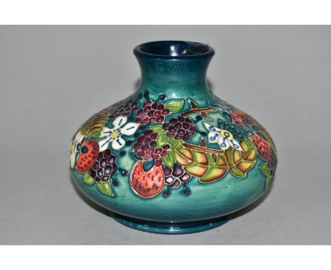 A MOORCROFT POTTERY CAROUSEL PATTERN VASE, of squat form, tube lined with flowers, berries and foliage on a blue-green ground