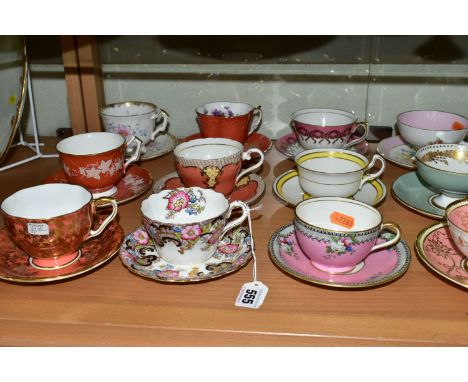 TWENTY ONE AYNSLEY TEA CUPS AND SAUCERS, assorted patterns including florals, gilt bands and solid colours, to include Majest