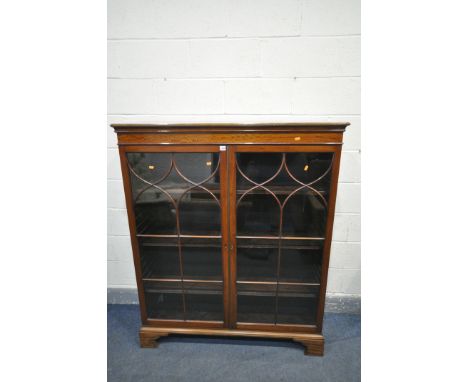 A GEORGIAN MAHOGANY TWO DOOR ASTRAGAL GLAZED BOOKCASE, with three adjustable shelves, on bracket feet, width 123cm x depth 40