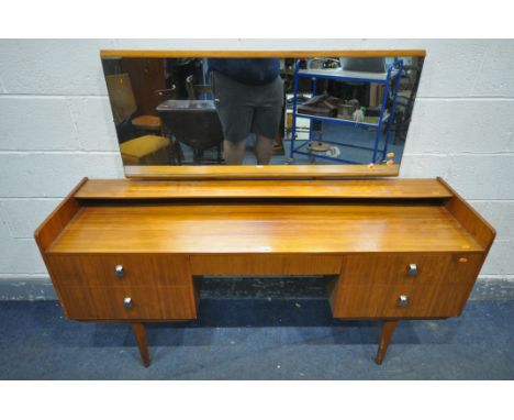 A MID CENTURY TEAK DRESSING TABLE, with a single rectangular mirror, a raised shelf, five various drawers, on cylindrical tap