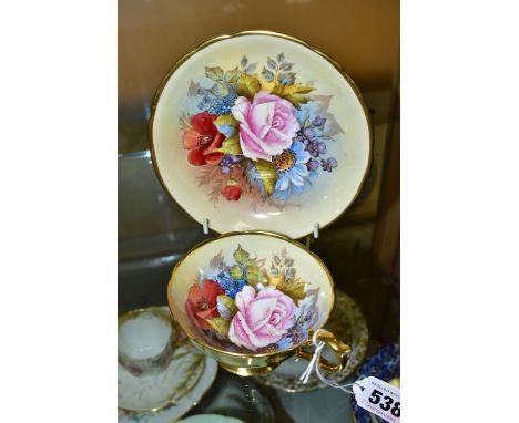 AN AYNSLEY FLORAL DECORATED TEA CUP AND SAUCER BY J. A. BAILEY, with wavy rims, cup having gilt exterior and handle, both bea