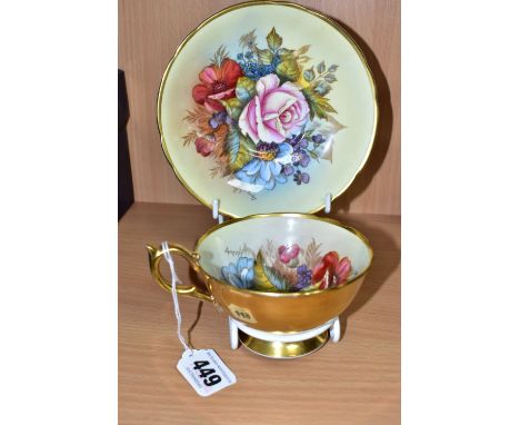 AN AYNSLEY FLORAL DECORATED TEA CUP AND SAUCER BY J. A. BAILEY, with wavy rims, cup having gilt exterior and handle, both bea