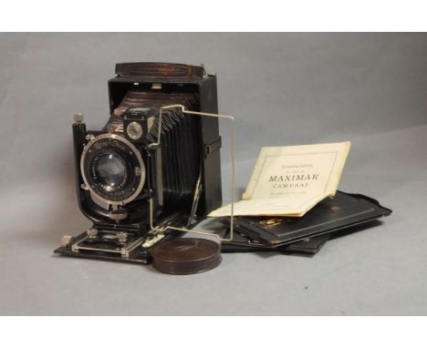 A Zeiss Ikon Folding Plate Camera,  Tessar 135mm F4.5 lens, together with 3 backs, original instruction manual and filters. 