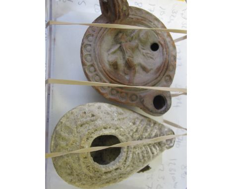 Roman 3rd. century red clay oil lamp with circular handle, outer edge double ring punched and central walking male figure hol