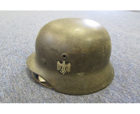 German Headwear - M 40 single Decal German helmet. Rear shell stamp. Small size liner complete, chinstrap present. Decal 90% 