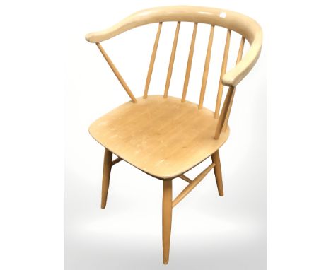 An Ercol elm and beech stick back armchair.