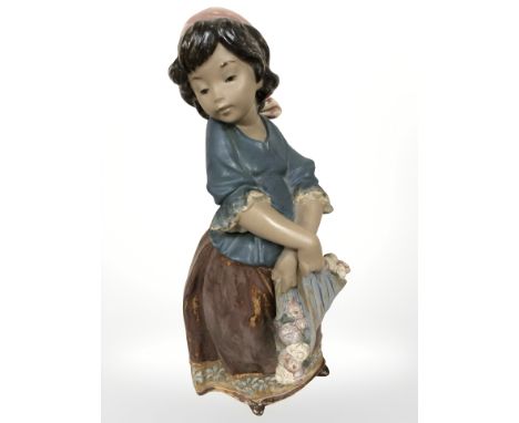 A Lladro bisque figure of a girl holding a bundle of roses, height 31 cm