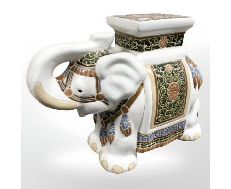 A ceramic elephant plant stand, height 43 cm.