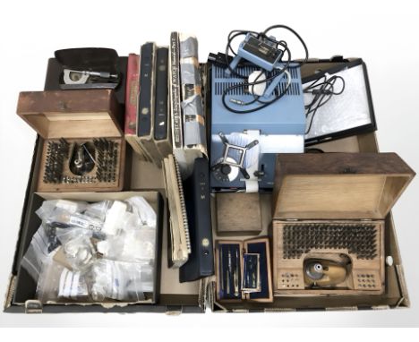 A collection of horologist's equipment, hardware including watch parts, movements, related volumes, small bakelite nine drawe