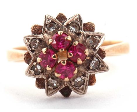 Ruby and diamond cluster ring the centre with four small round cut rubies raised above a star illusion setting highlighted wi