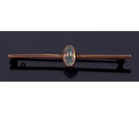 A vintage opal brooch, the oval cabochon stone bezel set onto a plain polished knife edge bar, stamped 9ct, 5cm long