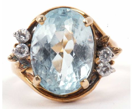 Large Topaz and paste set dress ring, the large oval faceted centered coloured stone highlighted with small white stone set c
