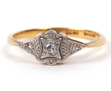 An Art Deco diamond ring centering a small round cut diamond box set between two diamond highlighted shoulders, stamped 18ct,