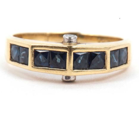 Sapphire and diamond designer ring, the angular top section set with eight calibre cut sapphires, pave set with a small diamo