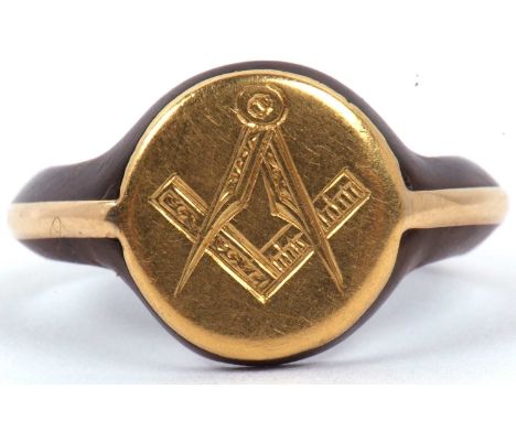 An antique Masonic gold and tortoiseshell ring, circa 1900, the round panel engraved with a set square and dividers, applied 