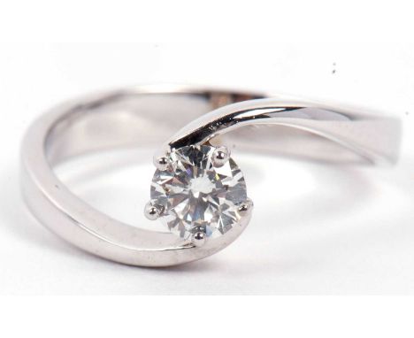 A precious metal single stone diamond ring featuring a round brilliant cut diamond, 0.40ct approx, raised between crossover s