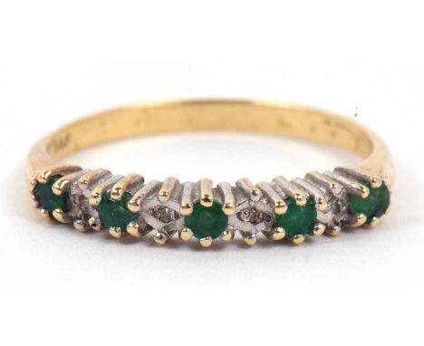 A modern emerald and diamond half hoop ring, alternate set with five small emeralds and four small diamond points, size L/M