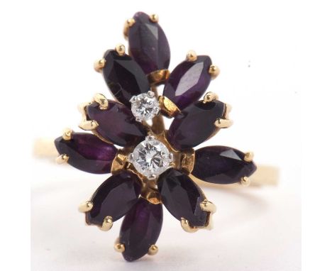 A 18ct gold amethyst and diamond cluster ring featuring two graduated brilliant cut diamonds raised between marquise shaped a