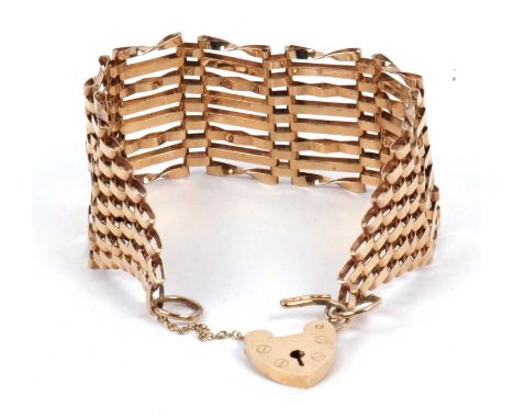 A 9ct gold four bar gate bracelet having a heart and padlock safety chain fitting, 16.6 gms