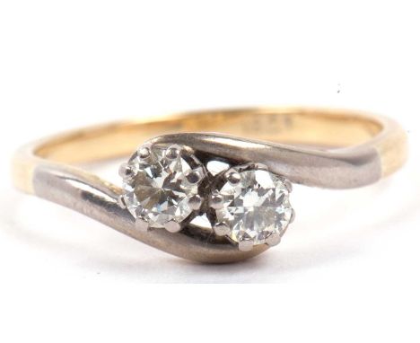 Two stone diamond crossover ring, the side by side round brilliant cut diamonds of 0.30ct total approx, raised between angula