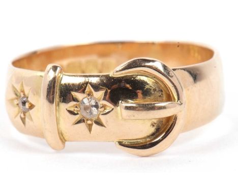 An antique 18ct gold and diamond buckle ring, the buckle highlighted with two small old cut diamonds in star engraved setting