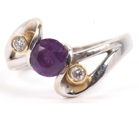 Modern amethyst and diamond crossover ring, the round faceted amethyst flanked by two small diamonds between stylised open wo
