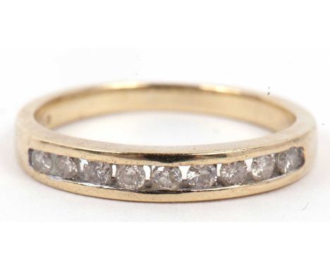 A modern 9ct gold and diamond half eternity ring, chanel set with nine small round cut diamonds, total ct weight 0.25ct appro