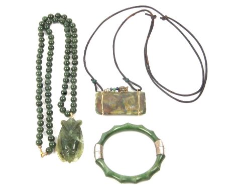 A mixed lot to include vintage green glass hinged bracelet, a  modern jade moth pendant on a 585 stamped bale suspended from 