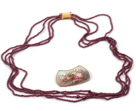 Mixed Lot: A vintage painted enamel brooch (a/f) together with a small red bead four strand necklace (2)