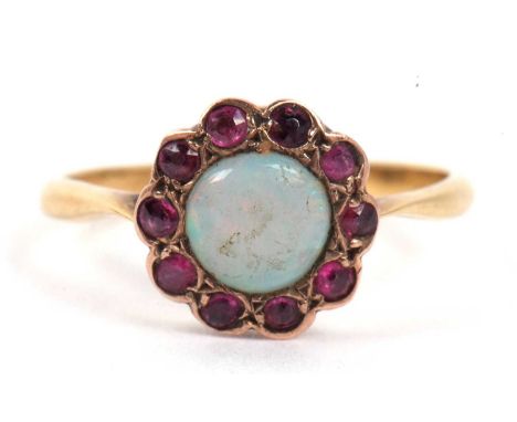 An opal and amethyst ring, the cabochon round cut opal surrounded by ten small amethyts, the enclosed setting stamped 9ct, si