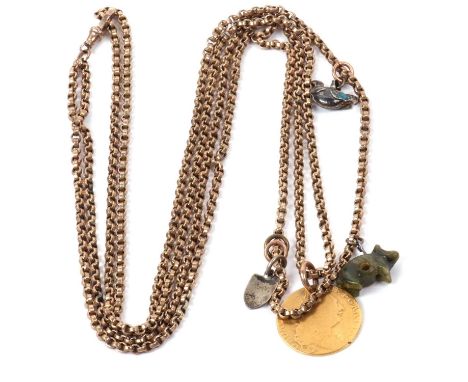 An antique 9ct gold long guard chain suspending a drill, George III 1775 gold guinea coin, two enamel charms and a green glas