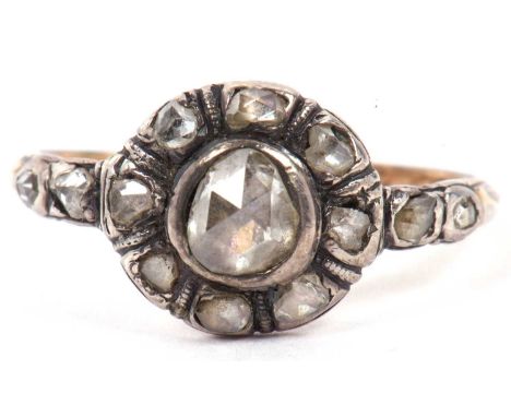 An antique old cut diamond cluster ring, centre stone is approximately 0.40ct, with small diamond tiered shoulders, enclosed 