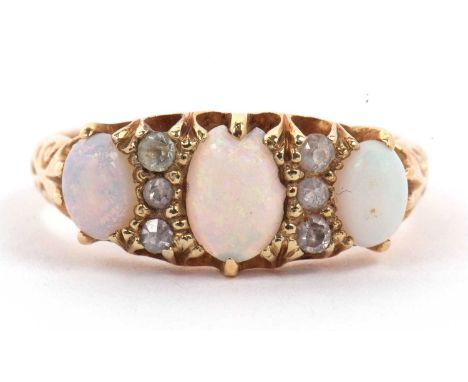 Antique 18ct gold opal and diamond ring featuring three graduated oval cabochon cut opals, highlighted between with six small