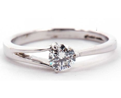 A solitaire diamond ring, a three claw set design with one single split shoulder, the round brilliant cut diamond is 0.50ct a