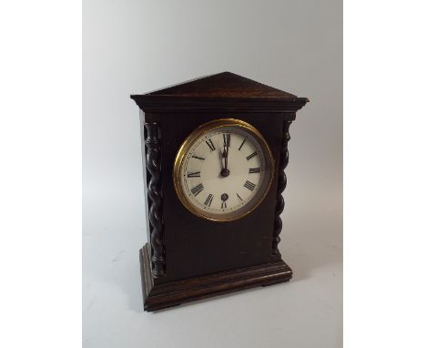 An Edwardian Oak Mantle Clock with Barley Twist Pilasters.