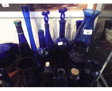 A Collection of Blue Glassware to Include Oil Lamp, Bottles, Decanters, Vases Etc. 