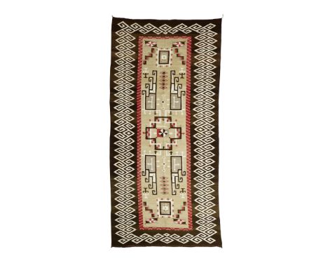 A large Navajo Teec Nos Pos rugDecorated with intertwined linear motifs with arrow accents and floating geometric accents, wi