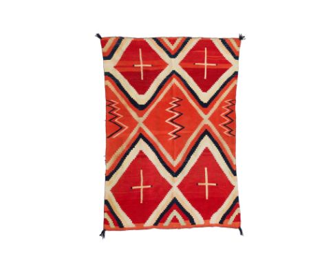 A Navajo classic period wearing blanketFinely woven in a pattern of stepped diagonal bands reserving striped crosses and zigz