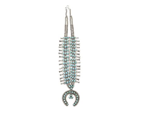A Zuni squash blossom necklaceA two-strand example with 30 blossoms, each overlaid with a bow tie-shaped plate set with three