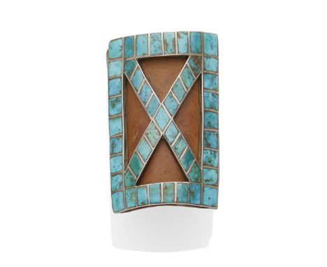 A Navajo or Zuni bowguardIn the form of an openwork St. Andrew's cross, inlaid with rectangular and diamond-shaped turquoise,