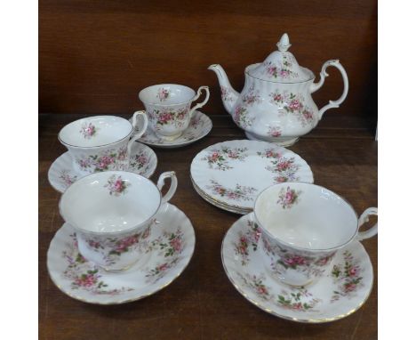 A Royal Albert Lavender Rose teapot, four cups and saucers and three side plates 