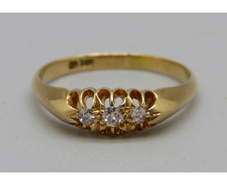 An 18ct gold, three stone diamond ring, 2.8g, O 