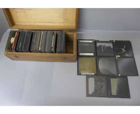 A wooden box with seventy assorted magic lantern slides 