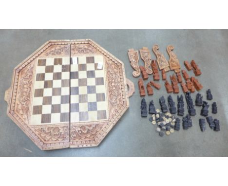 A games box with four legs and a carved chess set **PLEASE NOTE THIS LOT IS NOT ELIGIBLE FOR POSTING AND PACKING** 