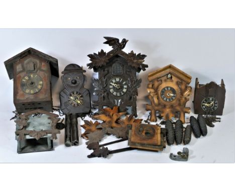 A collection of mid 20th century and later cuckoo clock parts, to include weights, cases and movements. (3) 