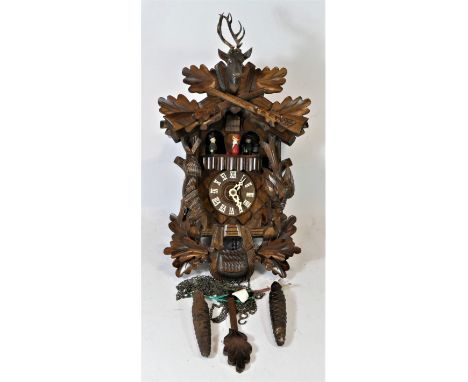 A Black Forest mechanical cuckoo clock, with central carved deer head & two rifles, made in Germany. L43cm. Lot 344 – The clo