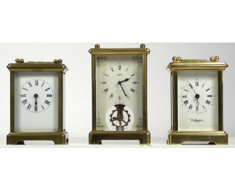 Three 8 day carriage clocks, brass cased with enamel dials having German and French movements. (3) 