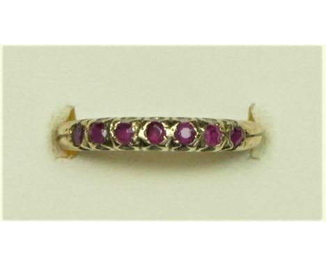 A 9ct gold and seven stone ruby ring, O, 1.5gm 