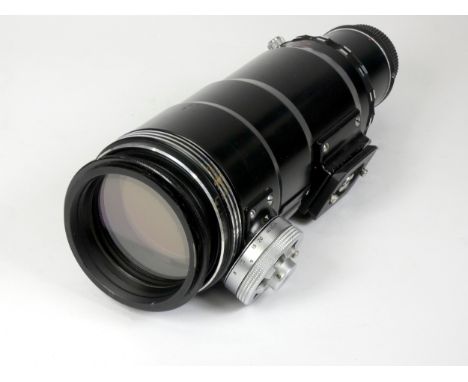 A Tair-3=PHS 'spy' lens, 300mm f4.5, made in the USSR, with lens cap and filter, together with a Manfrotto 222 Grip Action Jo