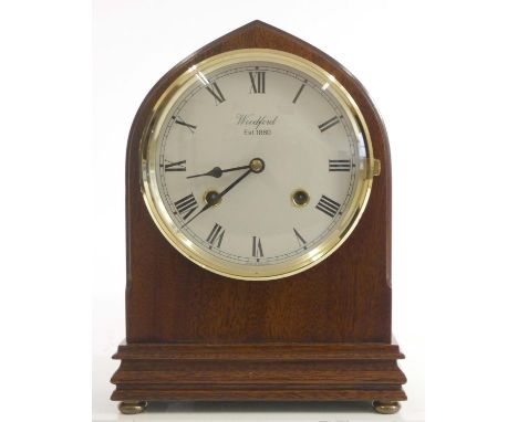 A Franz Hermle mantel clock, mahogany case, German 8 day movement striking to bell, standing on four brass bun feet. 22cm tal